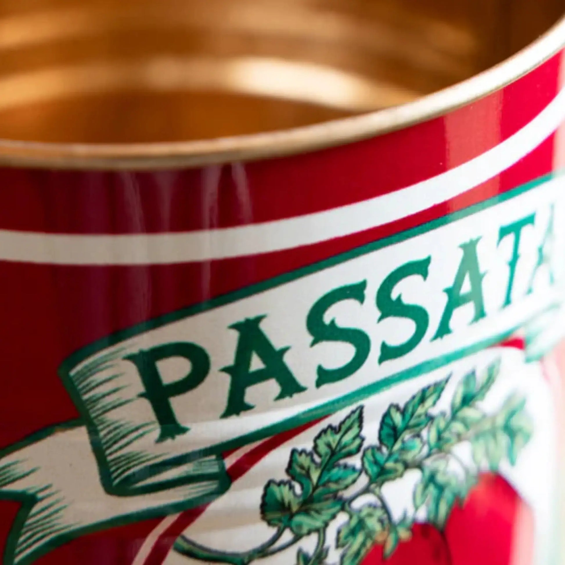 Close-up of a red can with 'PASSATA' branding and green text.