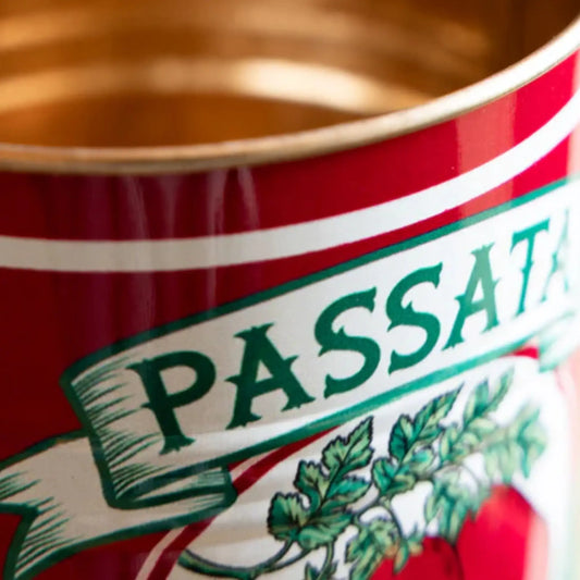 Close-up of a red can with 'PASSATA' branding and green text.