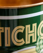 Close-up of a green can with 'Ticho' branding.