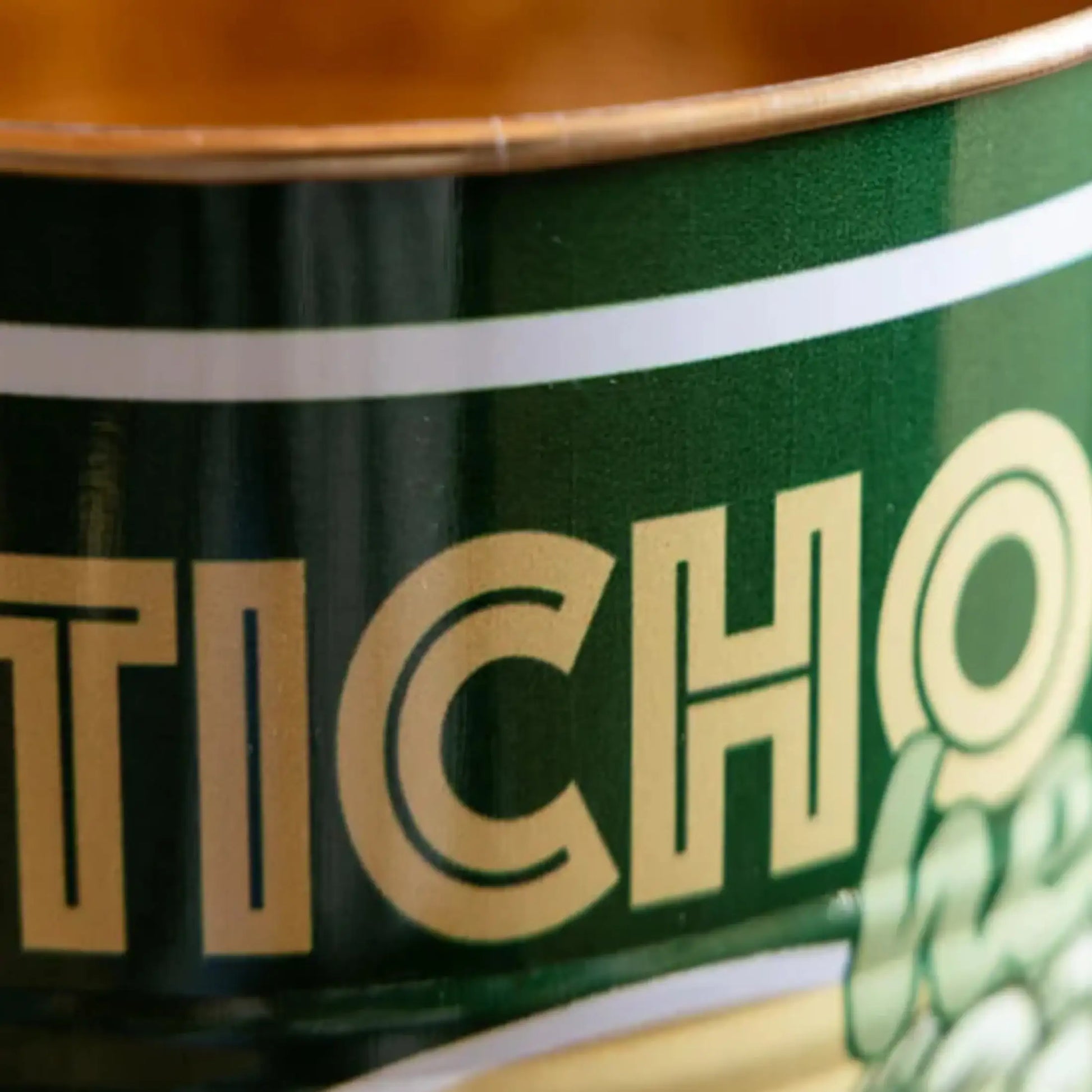 Close-up of a green can with 'Ticho' branding.