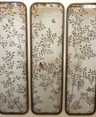 Three decorative wall mirrors with floral and bird patterns on a white background