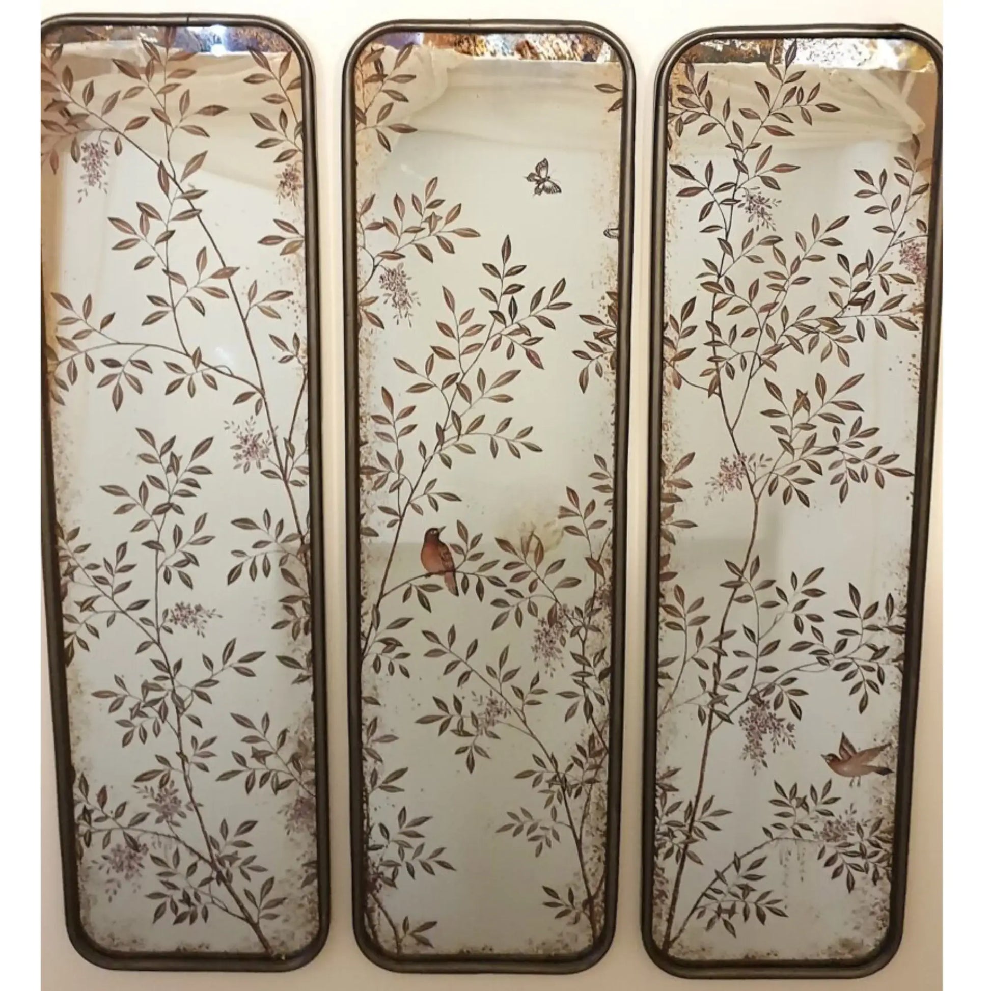 Three decorative wall mirrors with floral and bird patterns on a white background