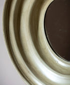 Close-up of a ceramic plate with concentric circular patterns on a neutral background