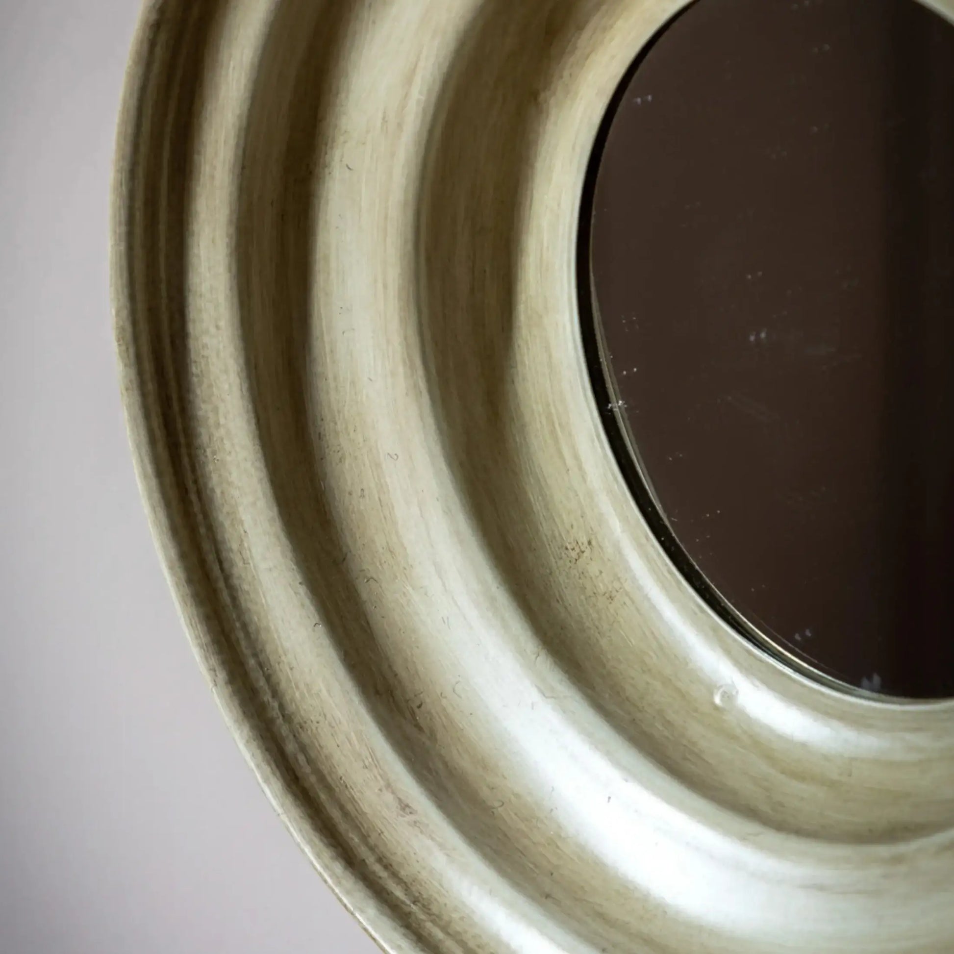 Close-up of a ceramic plate with concentric circular patterns on a neutral background