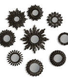 Set of black sunburst mirrors on a white background