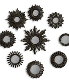 Set of black sunburst mirrors on a white background