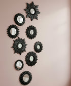 Set of black decorative mirrors with starburst designs on a white background