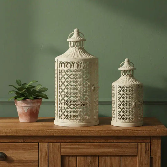 Two decorative lanterns on a wooden surface with a green wall background