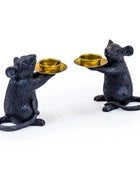 Two black mouse-shaped candle holders with gold bowls on a white background