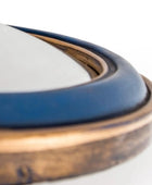 Close-up of a ceramic dish with blue interior and bronze exterior on a white background