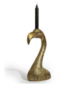 A sculptural candle holder shaped like a flamingo head in a textured metallic gold finish, holding a black taper candle, set against a plain white background.