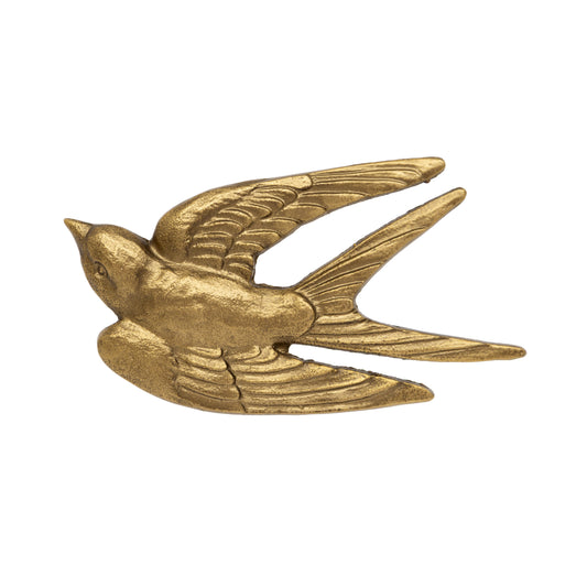 A metallic gold swallow bird figurine or ornament, shown in profile with wings spread, on a plain white background.