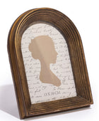 Wooden frame with silhouette and script paper on a white background