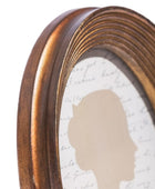 Close-up of a bronze-colored mirror frame with a textured white background