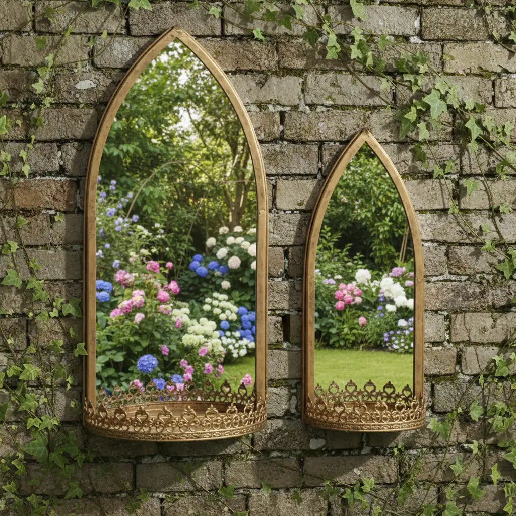 Two ornate mirrors on a stone wall reflecting a garden with flowers.