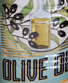 Close-up of an olive oil label featuring an illustration of green leaves, black olives, and a glass bottle filled with golden olive oil, with the text 'OLIVE OIL' in large black letters.