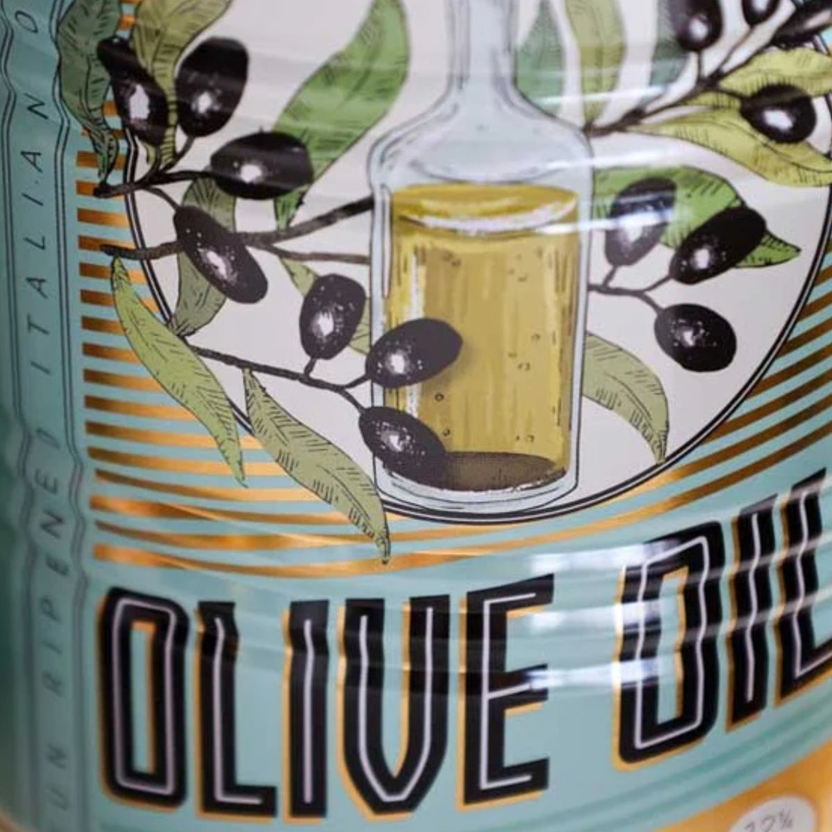 Close-up of an olive oil label featuring an illustration of green leaves, black olives, and a glass bottle filled with golden olive oil, with the text 'OLIVE OIL' in large black letters.