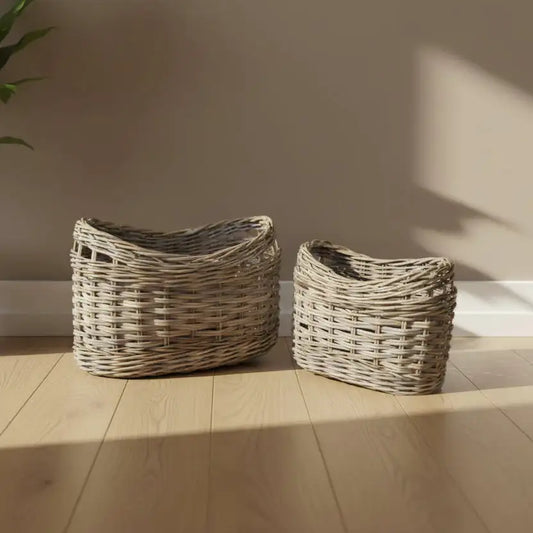 Two wicker baskets on a wooden floor with a neutral wall background