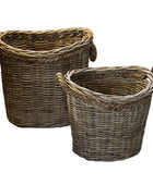 Two wicker baskets with handles on a white background