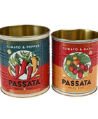 Two vintage-style metal Passata tomato cans with gold-toned interiors, shown side by side on a white background. The left can is labeled 'TOMATO & PEPPER' with red and blue graphics, and the right can is labeled 'TOMATO & BASIL' with red and orange graphics.