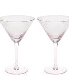 Two clear martini glasses with a delicate pink tint and vertical fluted detailing, shown side-by-side on a white background.