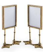 Two gold-framed stands with white backgrounds on a white background