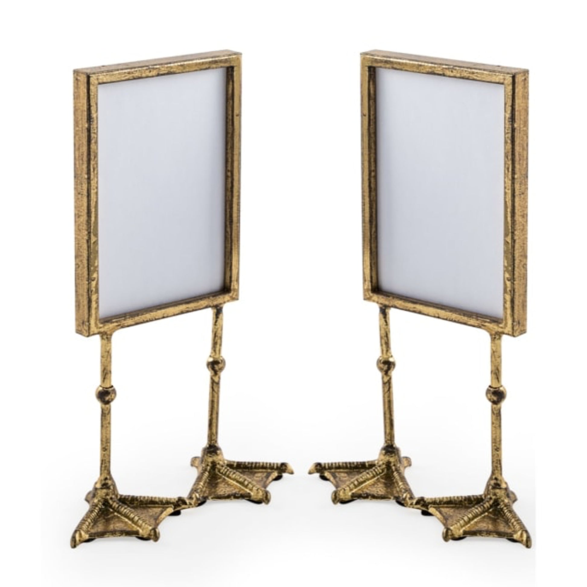Two gold-framed stands with white backgrounds on a white background