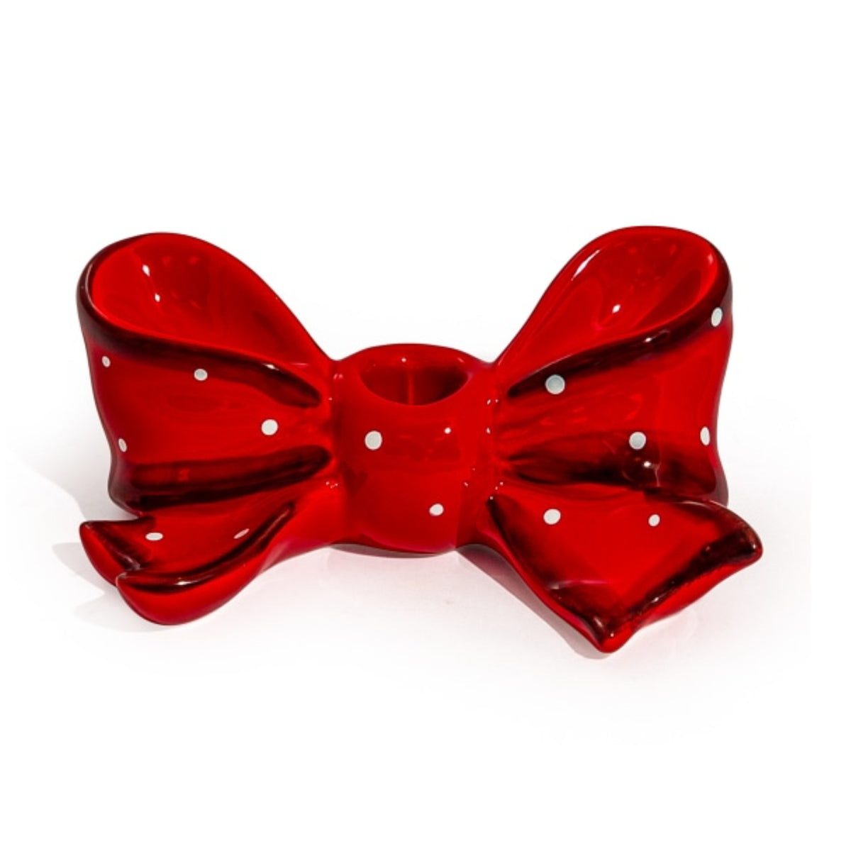 A glossy red bow-shaped candle holder with white polka dots, set against a plain white background.