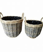 Two wicker baskets with handles on a white background