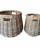 Two wicker baskets on a white background