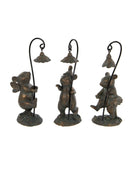 Three bronze bear figurines holding lanterns on a white background