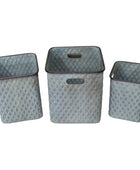 Three diamond-patterned metal baskets on a wooden surface with a neutral background