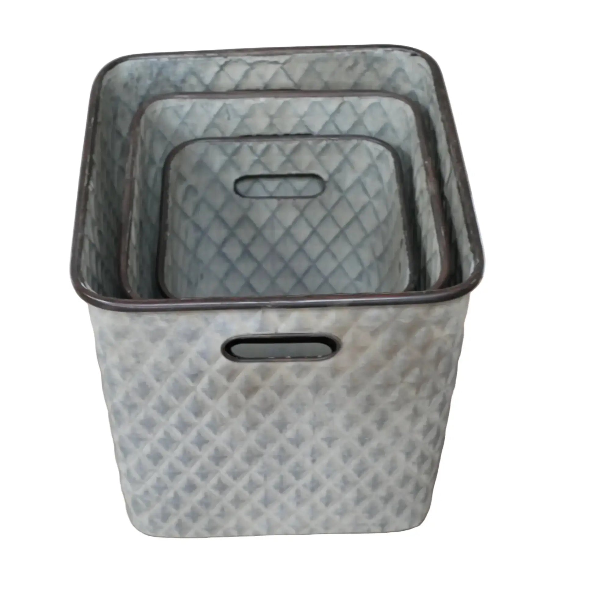 Set of three textured storage baskets on a wooden surface