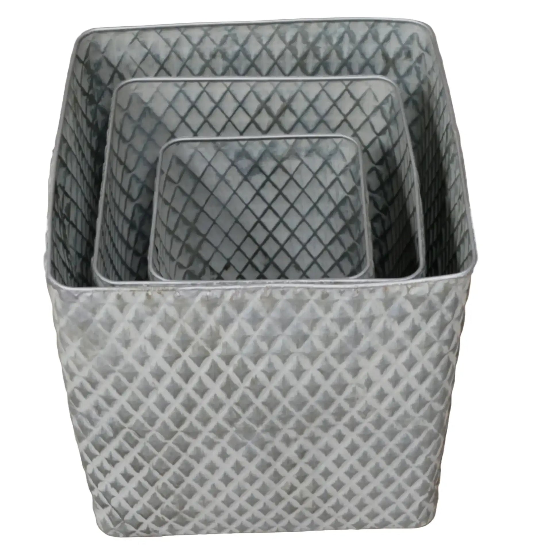 Set of three gray woven baskets on a wooden surface with a neutral background