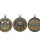 Three circular black-framed wall art pieces with hanging loops, each showing a different architectural design in gold and dark gray, displayed side by side on a white background.