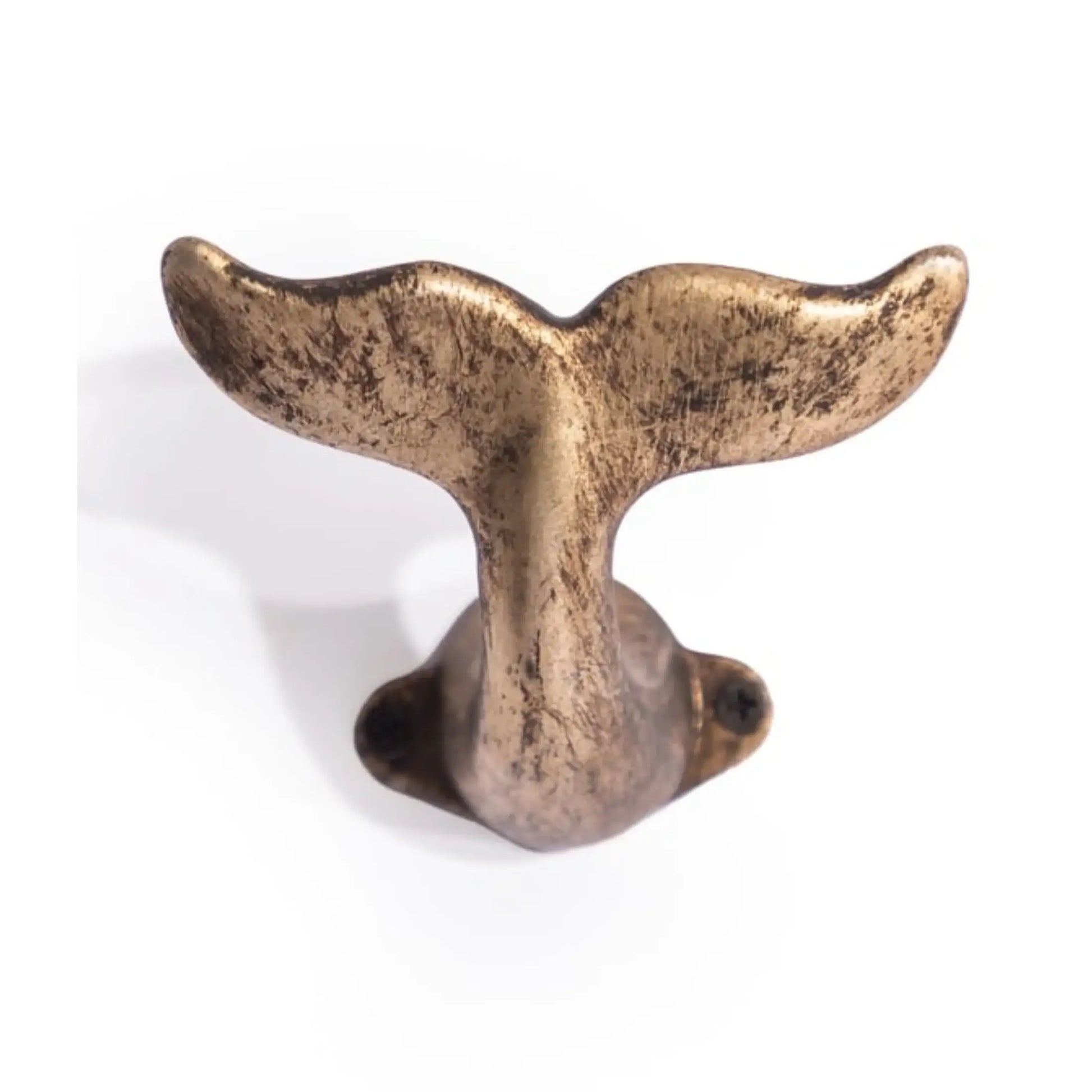 Bronze whale tail decorative item on a white background