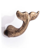 Bronze-colored whale tail ornament on a white background