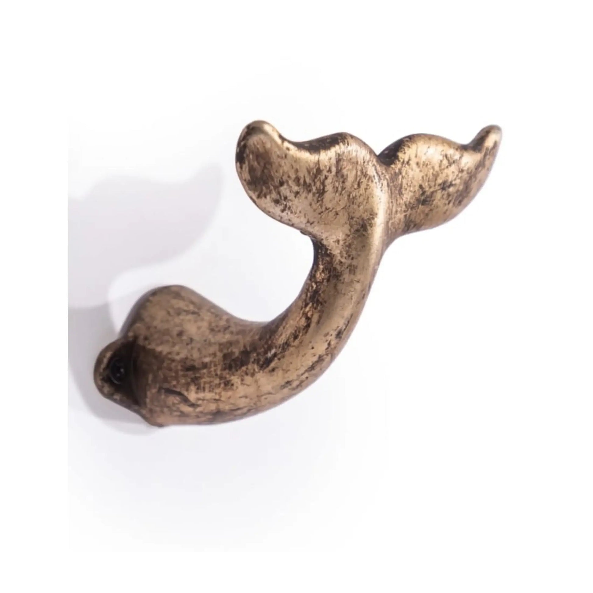 Bronze-colored whale tail ornament on a white background