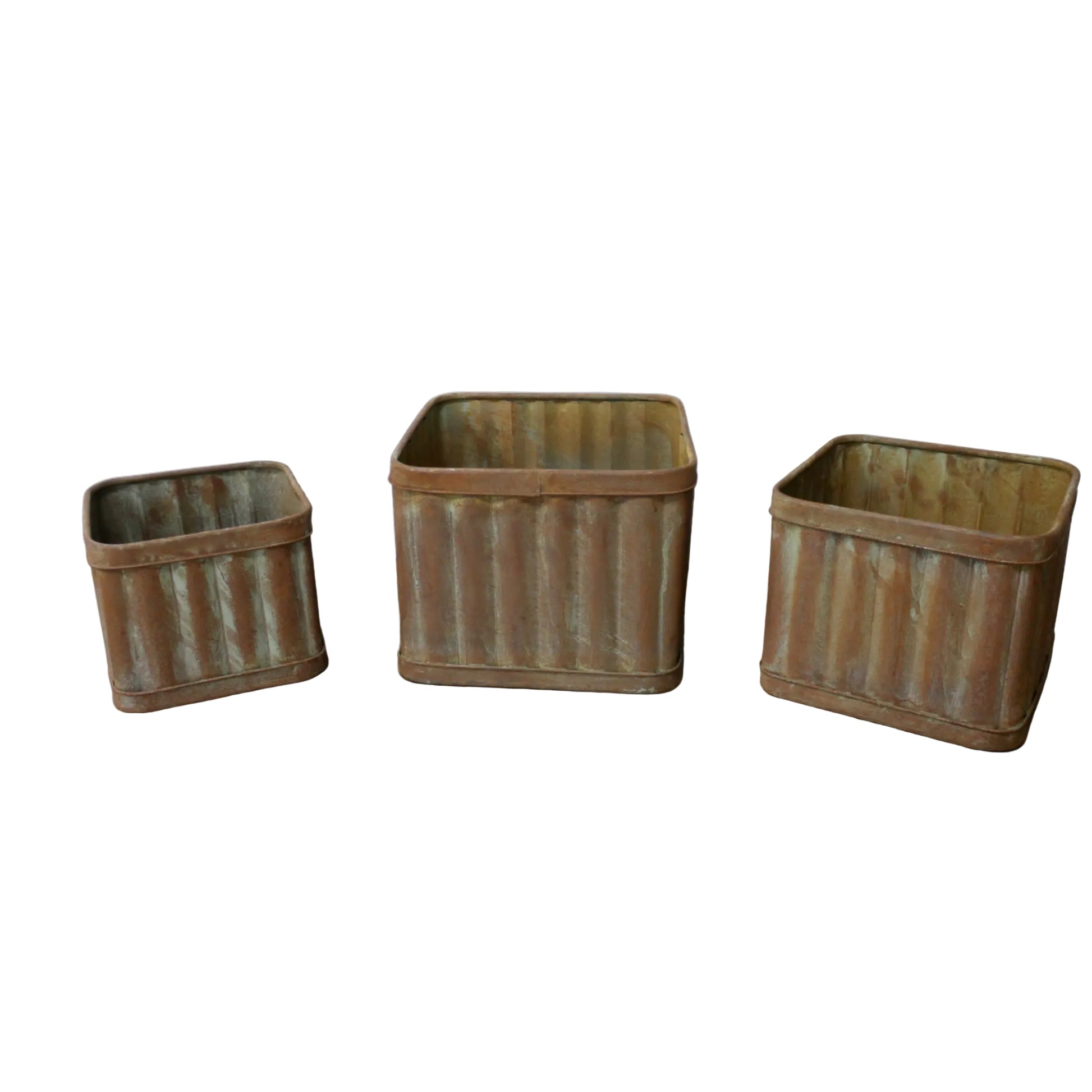 Three rustic metal baskets on a wooden surface with a white wall background