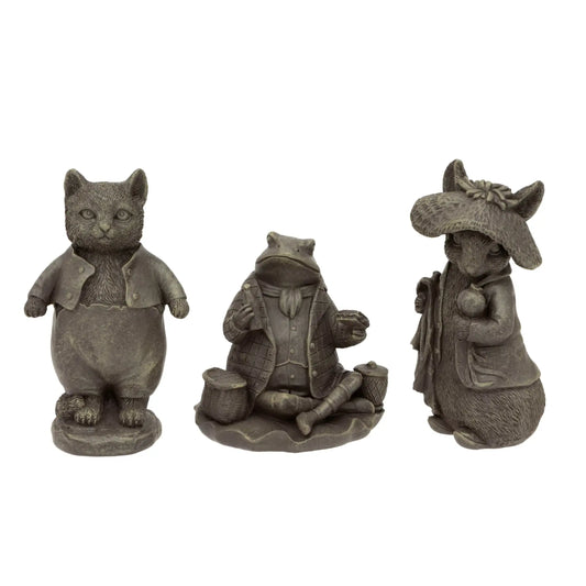 Three stone-like figurines of a cat, frog, and mouse on a white background