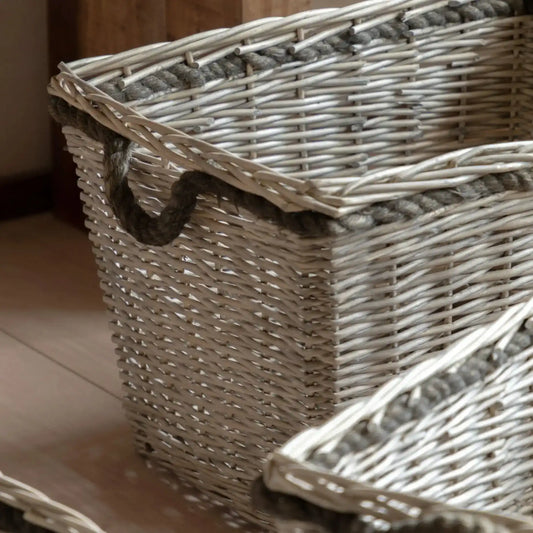 Wicker basket with a rope handle on a wooden surface