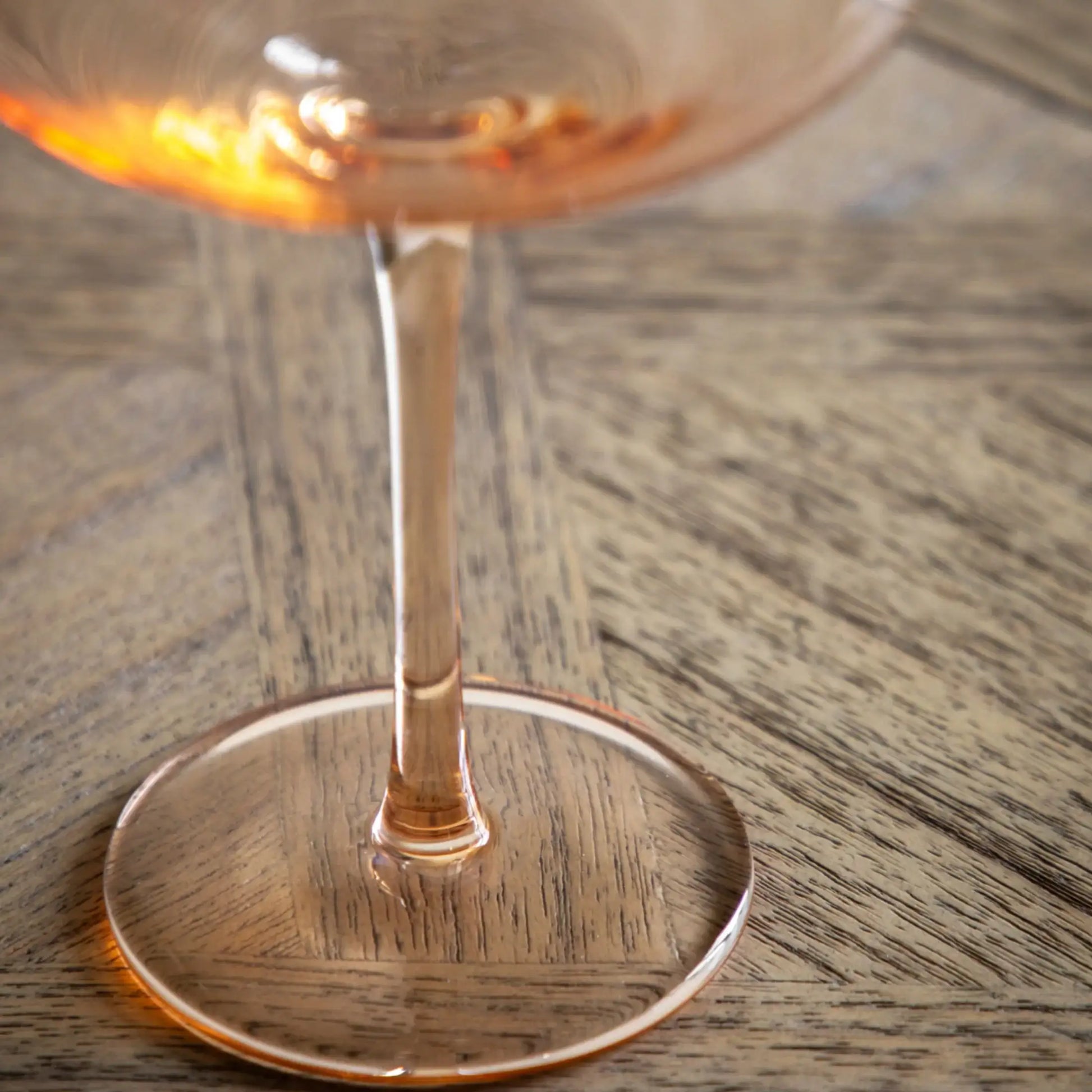 Wine glass with a drink on a wooden table