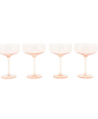 Four pink champagne glasses on a white background