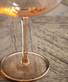 Wine glass with a drink on a wooden table