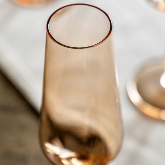 Rose gold champagne flute on a marble surface