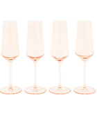 Four pink champagne flutes on a white background