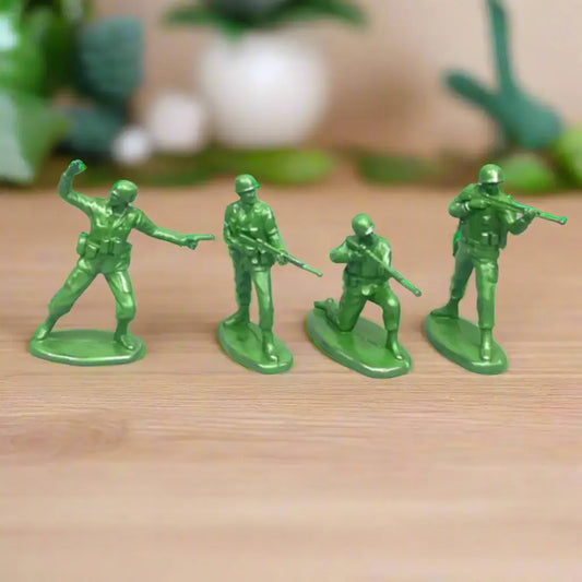 Four green toy soldiers on a white background