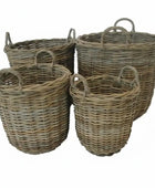 Set of four wicker baskets with handles on a white background