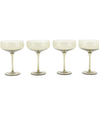 Four white cocktail glasses on a white background