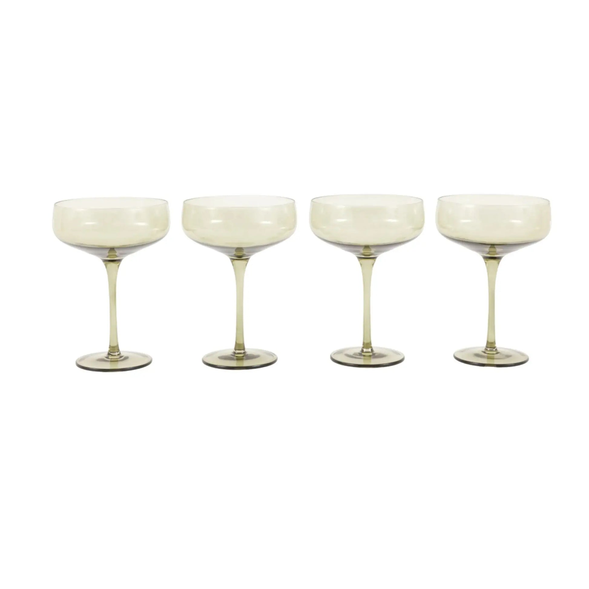 Four white cocktail glasses on a white background